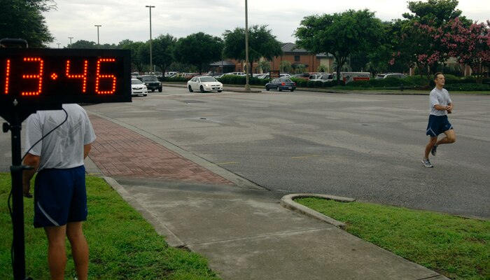 U.S. Air Force Capt. Josh Leanoeby finishes first during the two-and-a-half mile Commander's Fitness Challenge on Joint Base Charleston, S.C., July 1, 2010. This month's Commander's Fitness Challenge celebrated Year of the Air Force Family by offering a one-mile family and pet fun run, as well as an Information Fair in the Charleston Club's ballroom. Captain Leanoeby is with the 17th Airlift Squadron. (U.S. Air Force photo/Senior Airman Timothy Taylor)