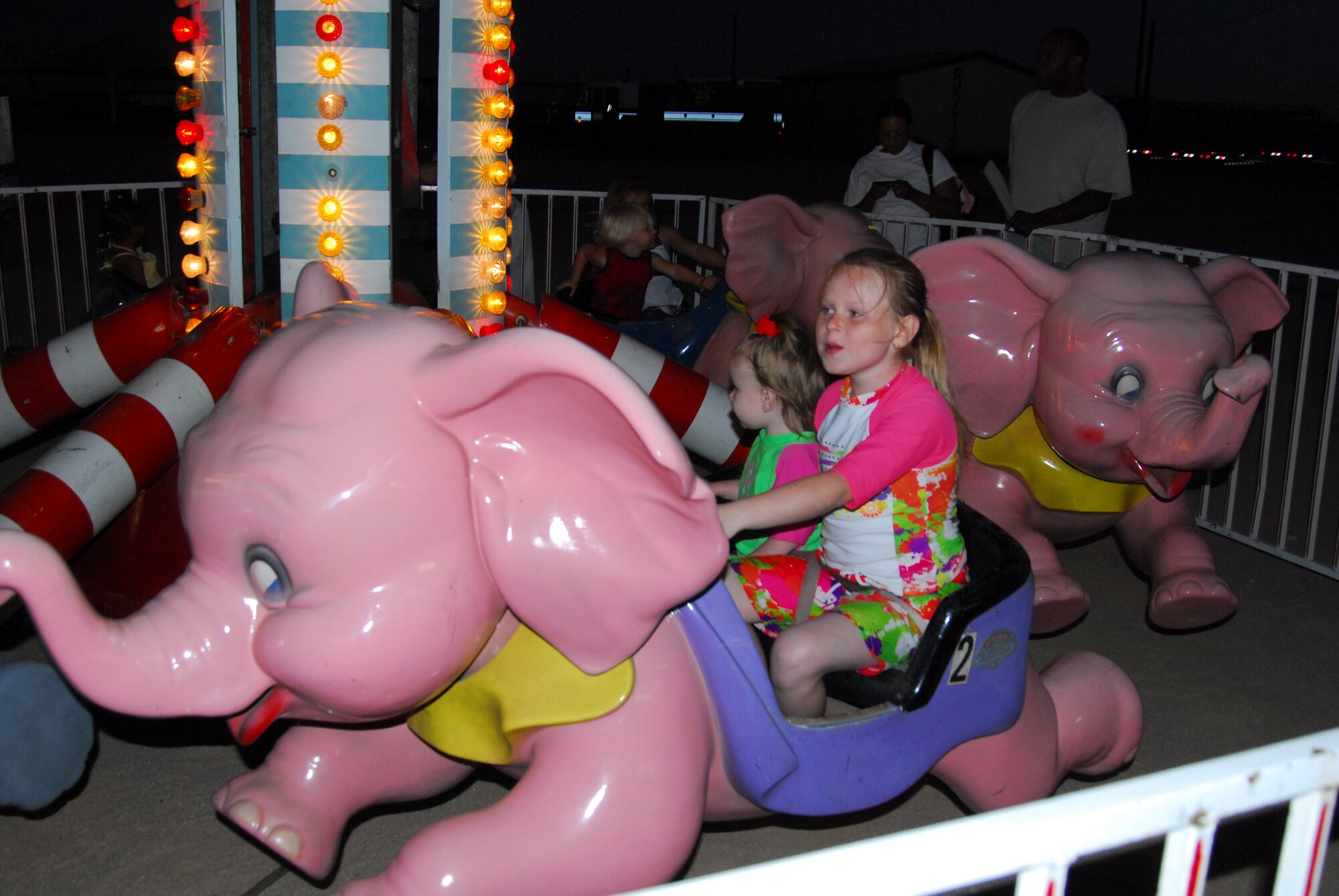 Seven-year-old Paige, and her younger sister, Chloe’, enjoyed the carnival rides, along with other activities at Summer Bash.  (Air Force photograph by Stephen K. Robinson)