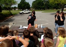Sarah Sherrill pours baking powder into a toy volcano during the summer reading program at the base library June 30, 2010 on Joint Base Charleston, S.C. The Department of Defense delegates the theme for the program each year, but are planned and carried out by the staff at the base library. This years theme is "Voyage to Book Island".  Miss Sherrill is a library technician in charge of programs and special events at the base library. (U.S. Air Force photo/Senior Airman Timothy Taylor)
