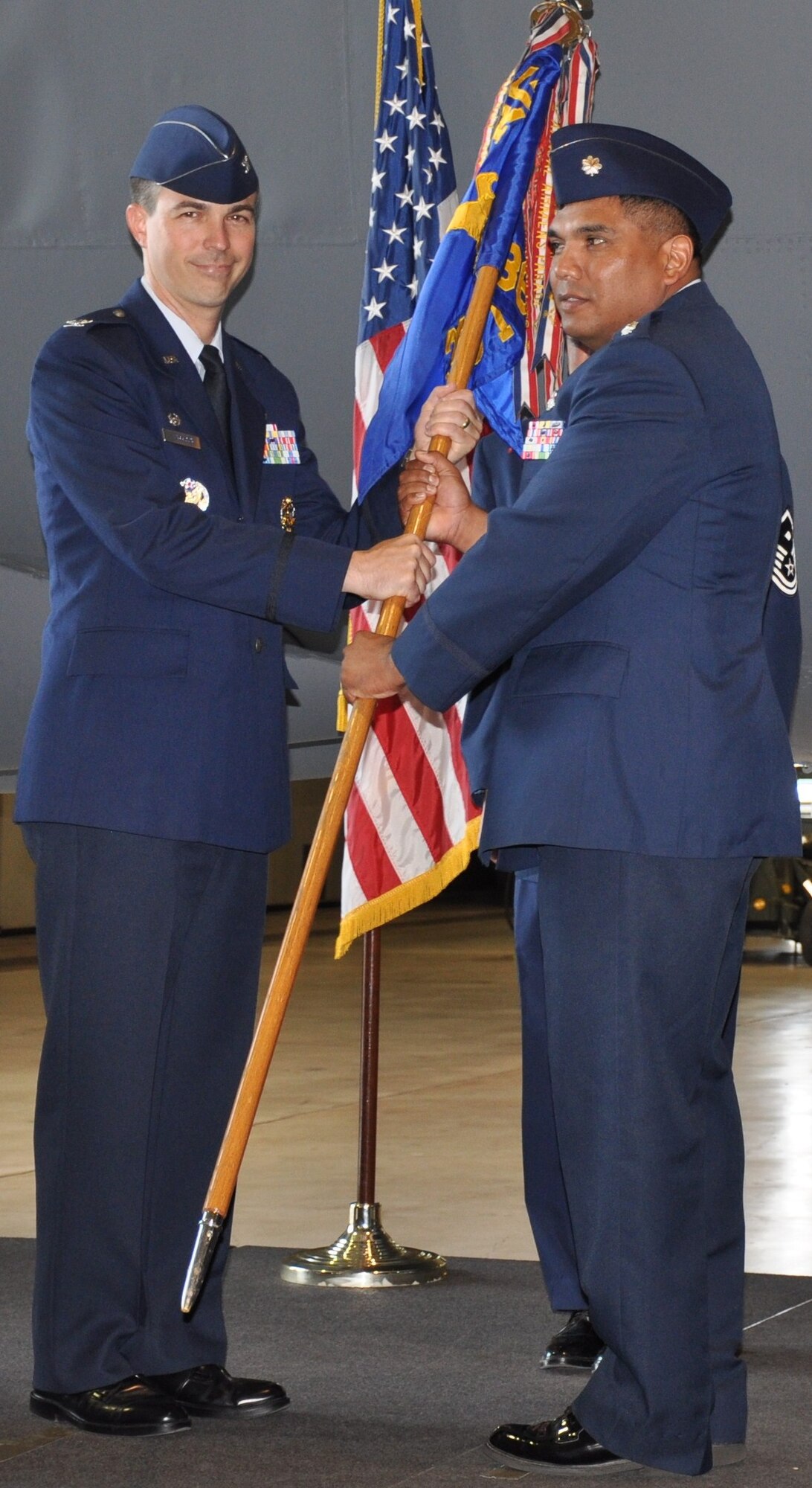 Lt. Col. Anthony Puente (right), incoming 363rd Training Squadron commander, takes command from Col. Shawn Harrison, 82nd Training Group commander, during a change of command ceremony in Bldg. 1045 at Sheppard Air Force Base, Texas, July 7, 2010.  The 363rd TRS trains more than 3,800 graduates in armament systems, nuclear and conventional munitions annually.  (U.S. Air Force photo/Tech. Sgt. Vernon Cunningham)