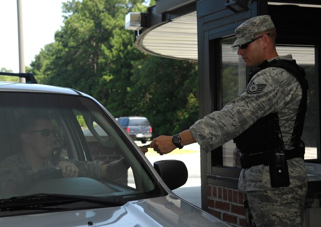 Tech. Sgt. Brian Saylors checks an identification card at the back gate on Joint Base Charleston, S.C., July 7, 2010. Sergeant Saylors is well known around the base for bellowing his trademark phrase ?motivated!? whenever anyone asks him how he is. Sergeant Saylors is not your typical Airman, he served five and a half years in the Marine Corps as a reconnaissance Marine during the war in Bosnia before making the transition to the Air Force. As a civilian Sergeant Saylors works as a paramedic at Berkley County Hospital. Despite his hard exterior, Sergeant Saylors said that he enjoyed helping people and saving lives.  During his one year tour as a security forces augmentee Sergeant Saylors has refined himself as a noncommissioned officer and stated that he wants to be known for his professionalism and dedication to the military. Sergeant Saylors is a fire protection journeyman with the 315th Civil Engineer Squadron. (U.S. Air Force Photo/Airman 1st Class Lauren Main)