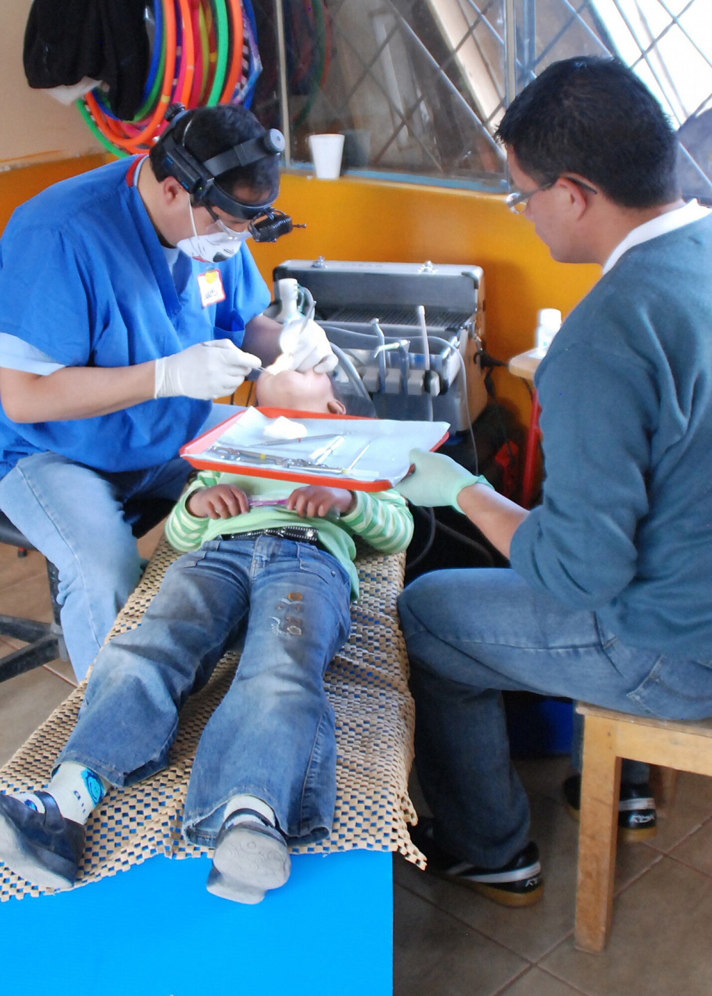 Volunteers perform dental surgery on a child during a Judith Lombeida Medical Foundation mission to Ecuador in April 2009. The foundation is named after Col. (Dr.) Judith Lombeida, who died in a car accident in 2006. The next Lombeida Foundation mission is scheduled for September. (photo courtesy of Mark Backlin)