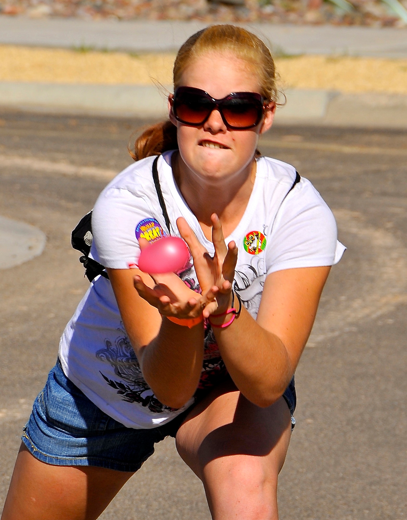 HOLLOMAN AIR FORCE BASE, N.M. -- Naomi Cobb, a resident of Alamogordo, participates in a water balloon tossing contest during the Holloman Air Force Base Fourth of July celebration July 2, 2010. This years celebration included music, food and rides for family members and their guests. (U.S. Air Force photo by Tech. Sgt. Chris Flahive/Released)