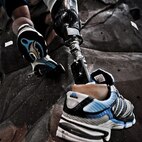 Conquering the rock climbing wall at the Center for the Intrepid is just one of the exercises physical therapist Alicia White (holding the safety rope) has McGuire perform. The rehabilitation therapy helps the lieutenant get used to the prosthetic he received after having his lower right leg amputated following a boating mishap last summer. (TSgt Samuel Bendet)