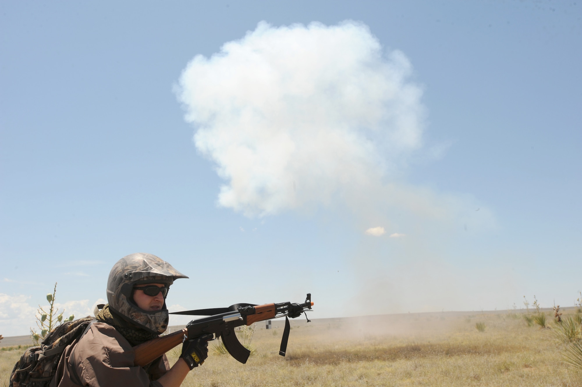 Staff Sgt. Kirk Baerlocher keeps watch as ground burst simulators explode all around during a capabilities exercise, June 26, 2010, at Cannon Air Force Base, N.M. The exercise gave insight into Cannon AFB's mission and capabilities. Sergeant Baerlocher is assigned to the 551st Special Operations Squadron. (U.S. Air Force photo/Airman 1st Class Maynelinne De La Cruz) 