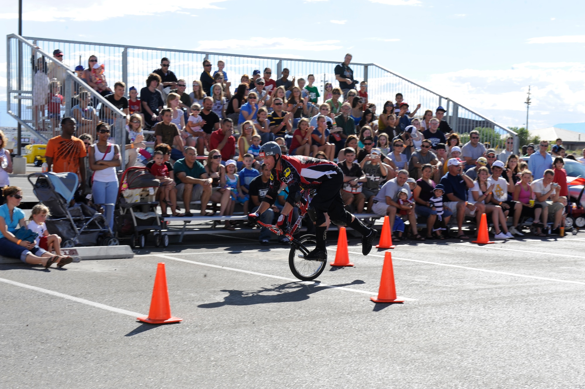 HOLLOMAN AIR FORCE BASE, N.M. -- Rob Nolli, a professional BMX rider with the BMX PROS Trick Team, performs a stunt for the crowd at the Fourth of July Block party at the Domenici Fitness and Sports Center parking lot July 2, 2010. Along with the Trick Team, the event had carnival rides, live entertainment and frozen t-shirt contests. (U.S. Air Force photo by Airman 1st Class Eileen Payne / Released)