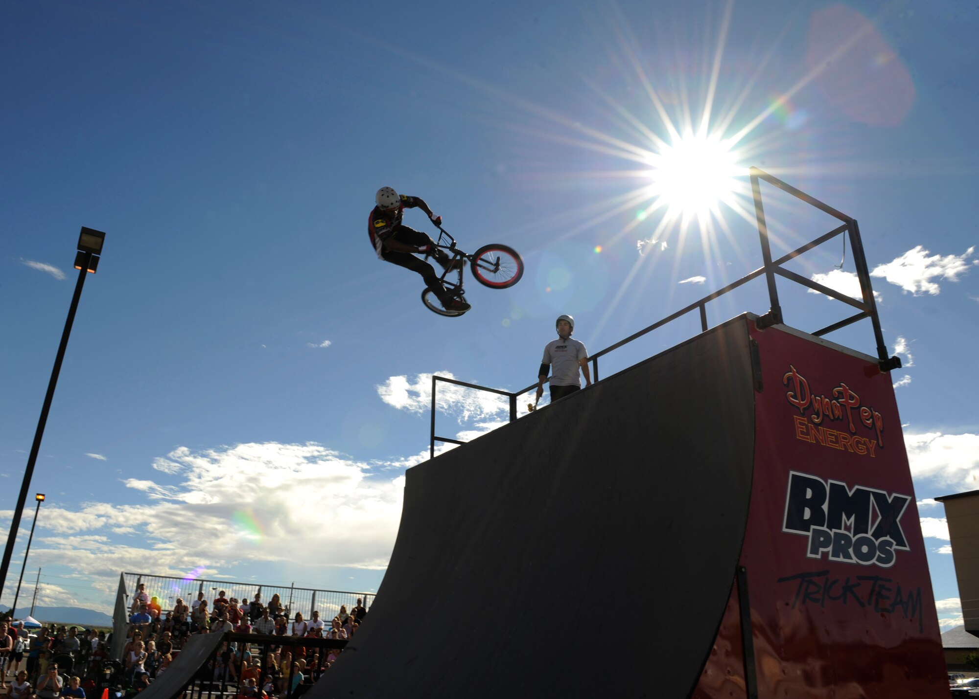 HOLLOMAN AIR FORCE BASE, N.M. -- Phil Haijal and Austin Coleman, both with the BMX PROS Trick Team, perform during the Fourth of July Block Party in the Domenici Fitness and Sports Center parking lot July 2, 2010. Along with the Trick Team, the event had carnival rides, live entertainment and frozen t-shirt contests. (U.S. Air Force photo by Airman 1st Class Eileen Payne / Released)