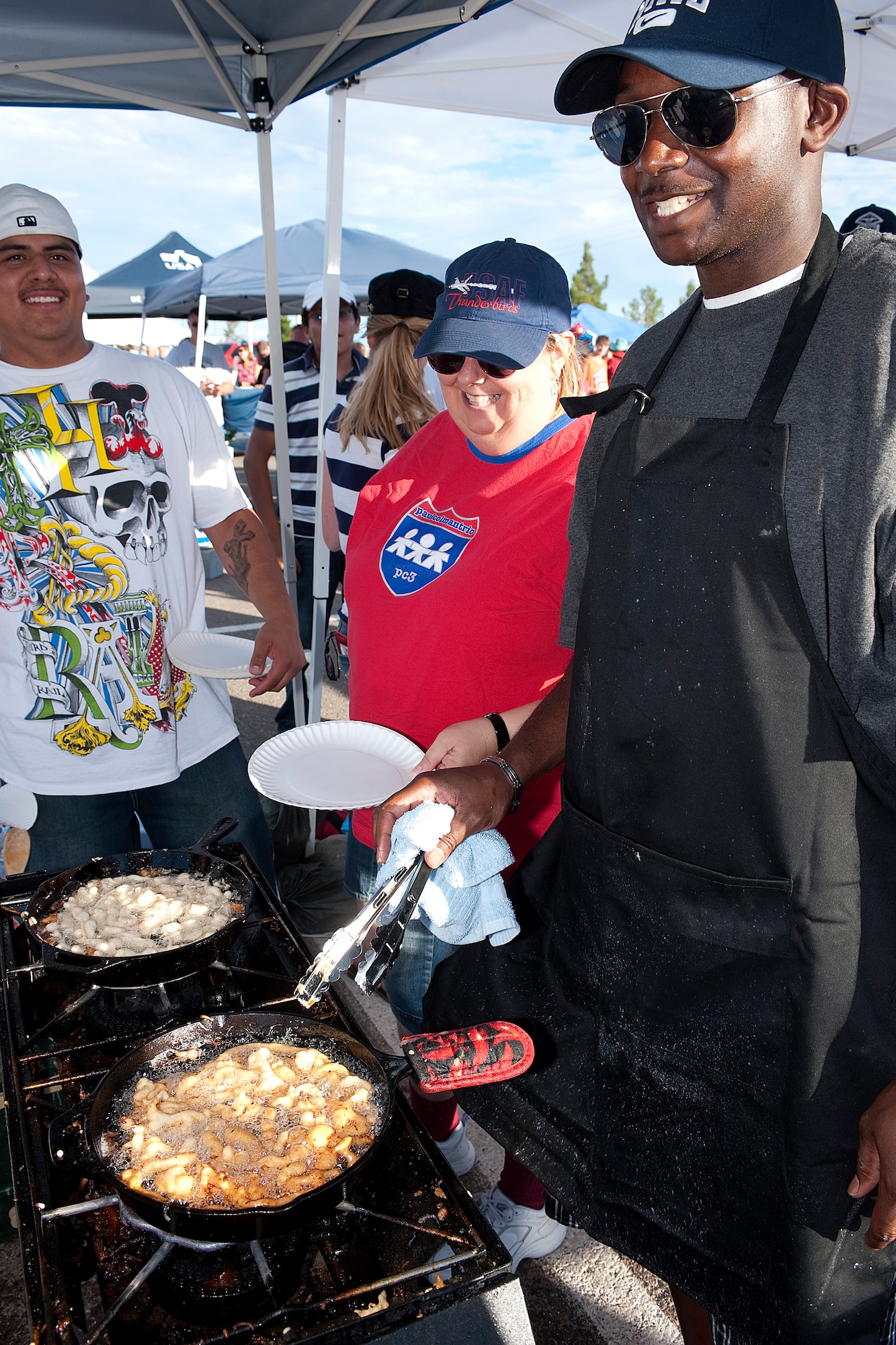 HOLLOMAN AIR FORCE BASE, N.M. -- Volunteers from the 49th Aeromedical Dental Squadron make funnel cakes to serve at the Fourth of July celebration July 2, 2010. Many organizations from around base offered different types of concessions to raise money for their respective booster clubs during the celebration. (U.S. Air Force photo by Senior Airman DeAndre Curtiss)