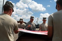 MINOT AIR FORCE BASE, N.D. -- Airman 1st Class Justin Baker, U.S. Air Force Honor Guard instructor, trains Airmen on proper procedures of a six-man flag fold here June 24. The U.S. Air Force Honor Guard’s Mobile Training Team traveled to Minot AFB to educate and train Airmen on basic protocol, honors and ceremonies, as well as create certified trainers for their units. (U.S. Air Force photo by Senior Airman Michael J. Veloz)