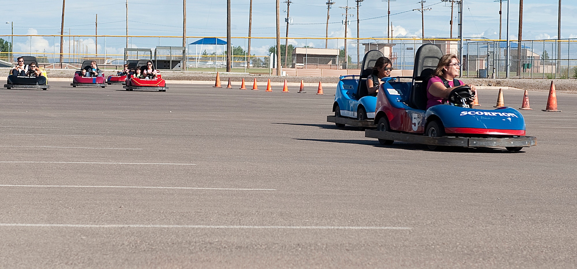 HOLLOMAN AIR FORCE BASE, N.M. -- People in attendance at the Fourth of July celebration drive go-karts around the parking lot of the softball field July 2, 2010. The go-karts were one of the many attractions provided for the celebration of Independence Day. (U.S. Air Force photo by Senior Airman DeAndre Curtiss / Released)