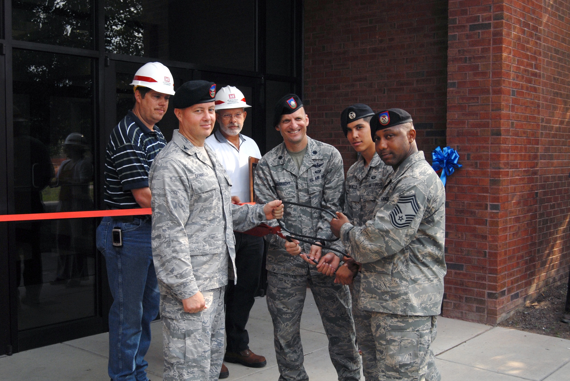 Col. Peter Donnelly, 18th Air Support Operations Group Commander, Lt. Col. Anthony Abernathy, 14th Air Support Operations Squadron Commander, Chief Master Sgt. Kenneth Lindsey, one of the first 14th ASOS members and Airman 1st Class Kyle Fairfield, the youngest member of the 14th ASOS, prepare to cut the ribbon of their new building July 1. The 14th ASOS’s mission is to support the 82nd Airborne Division with air and space power expertise and integration. (U.S. Air Force photo/Senior Airman Kris Levasseur) 