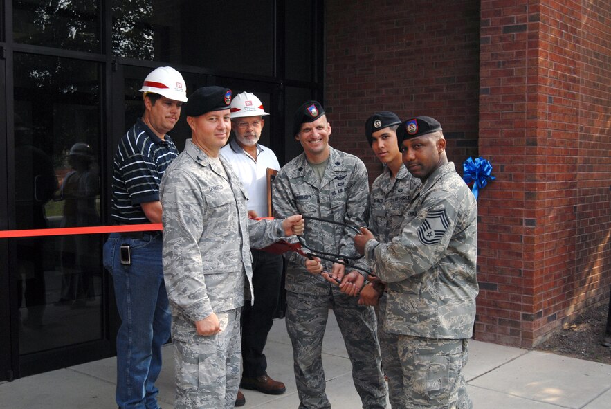 Col. Peter Donnelly, 18th Air Support Operations Group Commander, Lt. Col. Anthony Abernathy, 14th Air Support Operations Squadron Commander, Chief Master Sgt. Kenneth Lindsey, one of the first 14th ASOS members and Airman 1st Class Kyle Fairfield, the youngest member of the 14th ASOS, prepare to cut the ribbon of their new building July 1. The 14th ASOS’s mission is to support the 82nd Airborne Division with air and space power expertise and integration. (U.S. Air Force photo/Senior Airman Kris Levasseur) 
