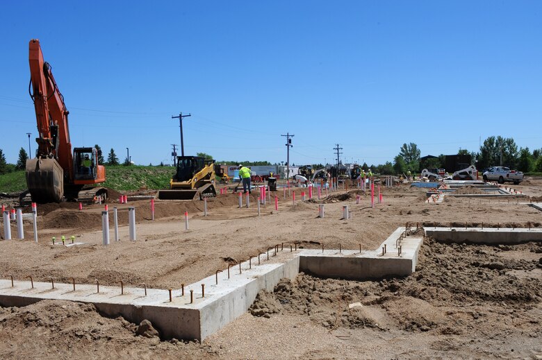 MINOT AIR FORCE BASE, N.D. -- Construction workers build on the foundation for a new dormitory here June 29. The new dorm will consist of 168 rooms and will heighten Airmen’s morale, allowing them to better accomplish the base’s mission. (U.S. Air Force photo by Airman 1st Class Aaron-Forrest Wainwright)