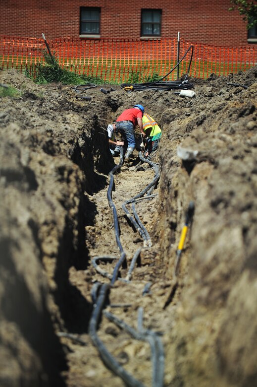 MINOT AIR FORCE BASE, N.D. -- Construction workers install a geothermal heating system for Geiger Hall dormitory to replace outdated heating system here June 29. Geothermal heating is the use of the Earth's thermal energy to provide cooling or heating (U.S. Air Force photo by Airman 1st Class Aaron-Forrest Wainwright)  