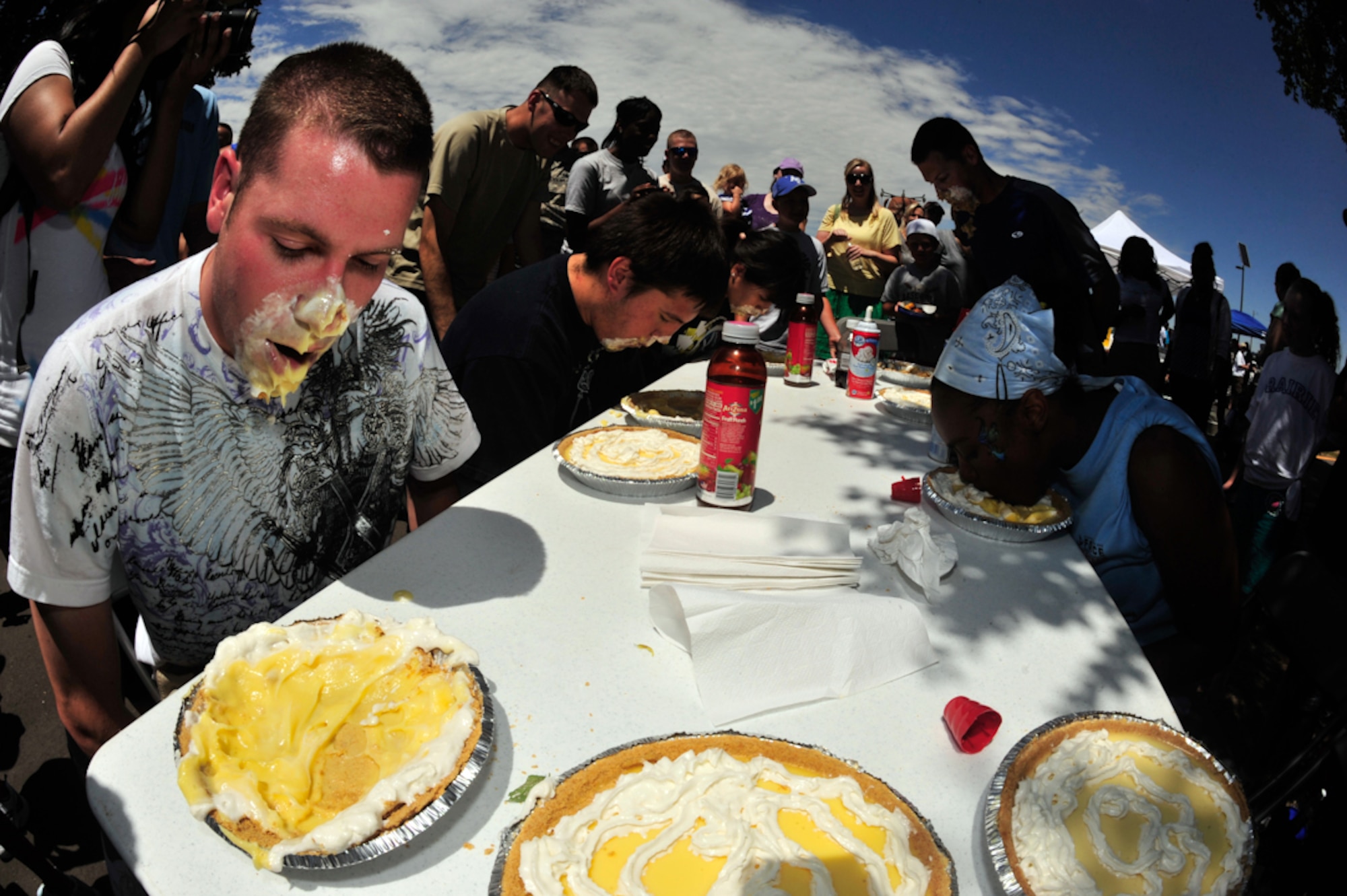 BUCKLEY AIR FORCE BASE, Colo. --  Contestants dig in to vanilla pudding pies for prizes during the pie-eating contest at Freedom Fest July 1. (U.S. Air Force photo by Staff Sgt. Kathrine McDowell)