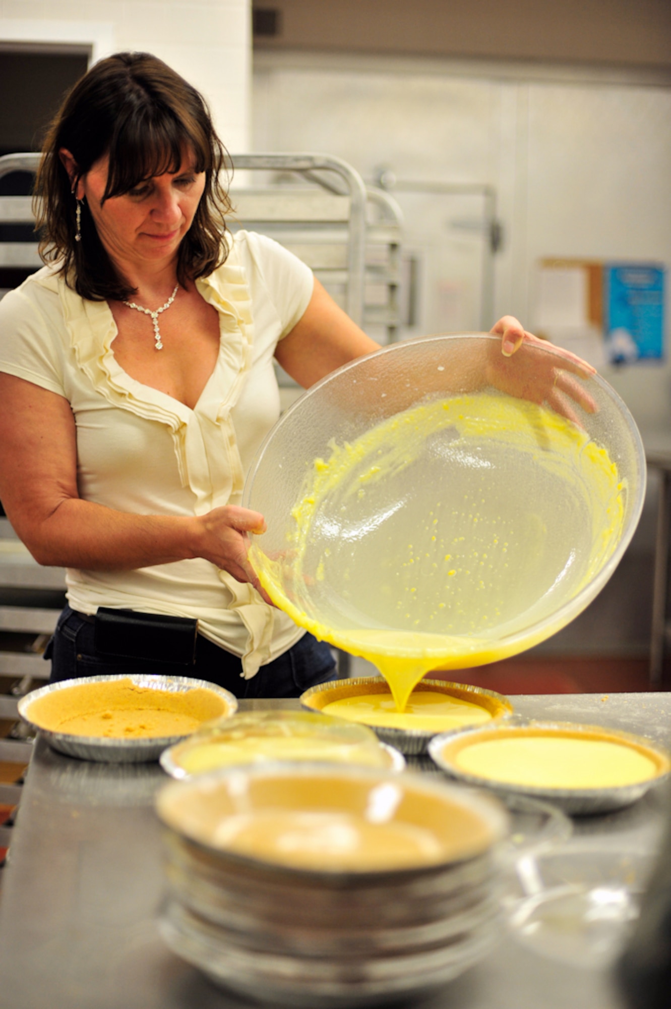 BUCKLEY AIR FORCE BASE, Colo. --  Barbara Magyar, 460th Force Support Squadron marketing, pours vanilla pudding into the pie crust June 30 in preparation for the pie-eating contest at Freedom Fest the next day. (U.S. Air Force photo by Staff Sgt. Kathrine McDowell)
