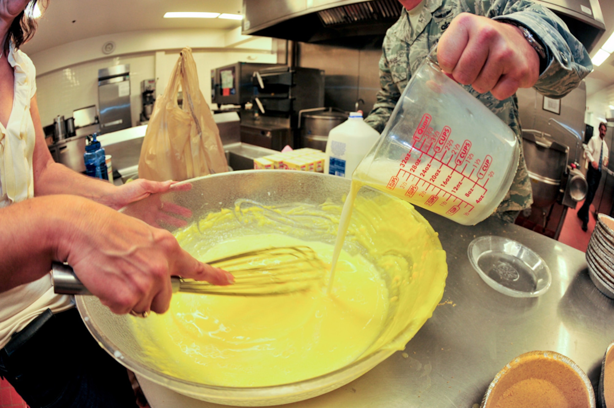 BUCKLEY AIR FORCE BASE, Colo. --  Barbara Magyar, 460th Force Support Squadron, and Tech. Sgt. Scott McNabb, 460th Space Wing Public Affairs, whip up vanilla pudding pie filling June 30. (U.S. Air Force photo by Staff Sgt. Kathrine McDowell)