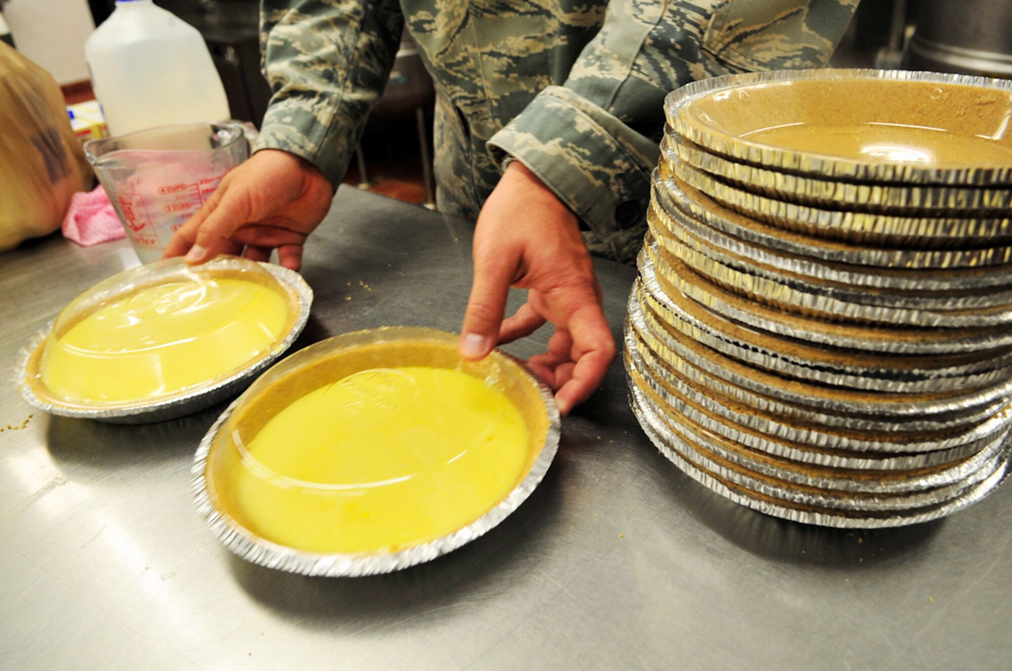 BUCKLEY AIR FORCE BASE, Colo. --  Tech. Sgt. Scott McNabb, 460th Space Wing Public Affairs, puts the lid on vanilla pudding pies June 30. The 50 pies were eaten during Freedom Fest's pie-eating contest July 1. (U.S. Air Force photo by Staff Sgt. Kathrine McDowell)