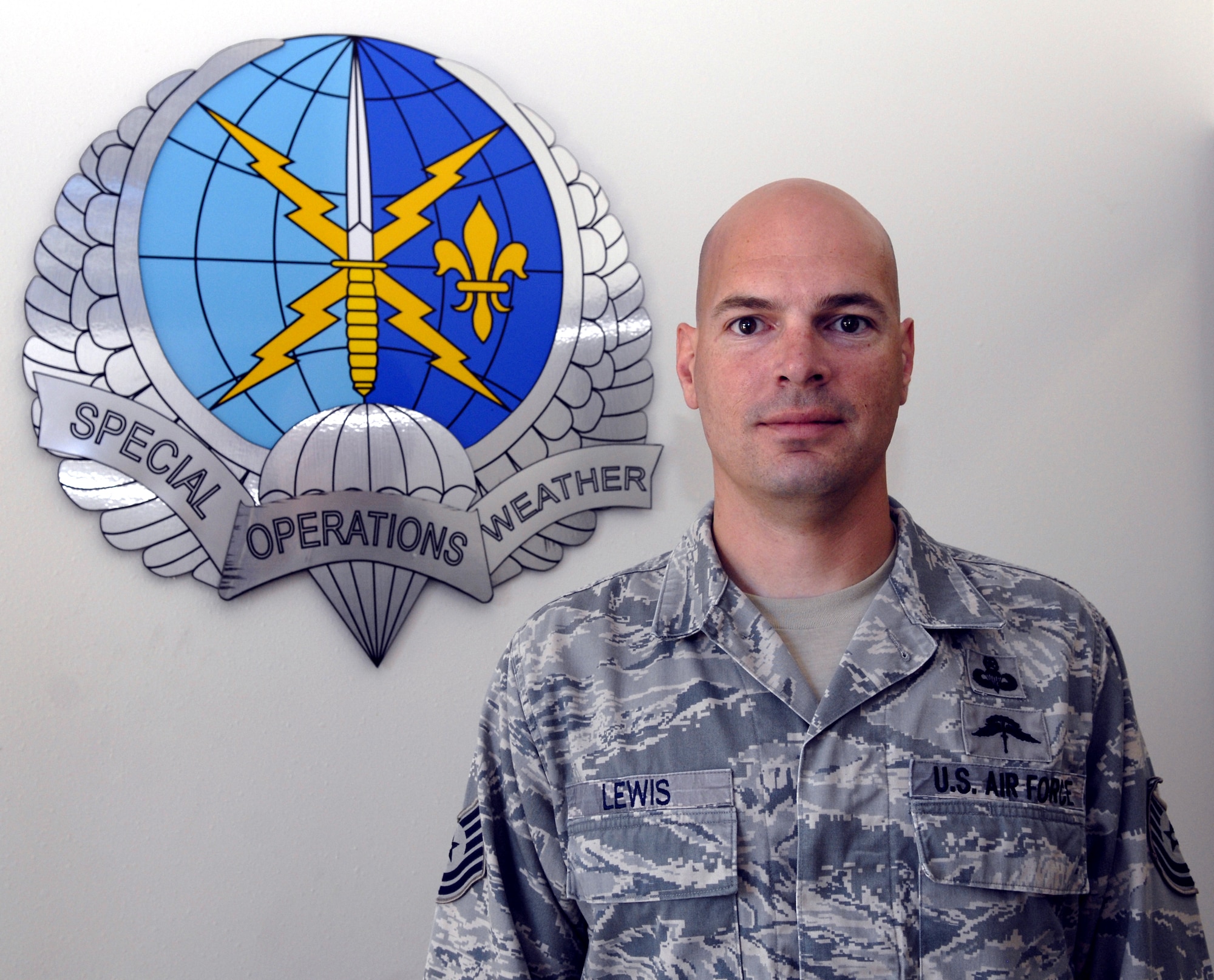Tech. Sgt. Josh Lewis, 10th Combat Weather Squadron special operations weather technician, poses in front of the 10th CWS logo at his squadron's building at Hurlburt Field, Fla., July 7, 2010. Sergeant Lewis was selected for this week's "Tip of the Spear" spotlight. (DoD photo by U.S. Air Force Airman 1st Class Joe McFadden/RELEASED)
