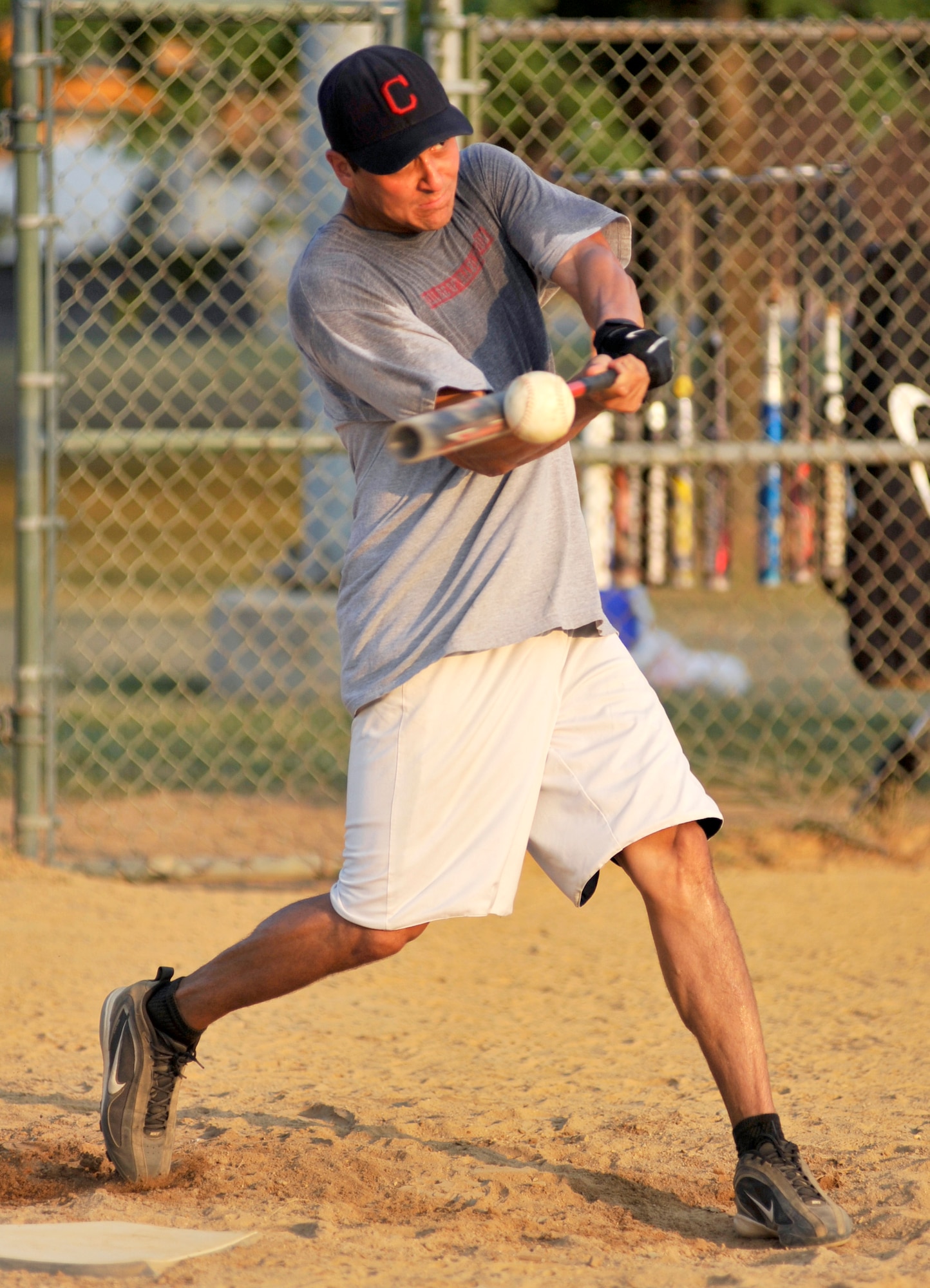 Harry Pollock, 436th Comptroller Squadron second baseman, raps a base hit in a National League softball game against the 436th Communications Squadron at the base softball field Dover Air Force Base, Del., July 6, 2010. Pollock went 2-for-4 from the plate as CPTS defeated Comm 12-11. (U.S. Air Force photo by Tech. Sgt. Chuck Walker/Released)