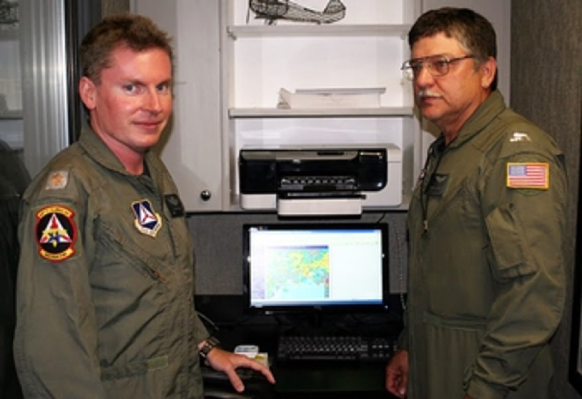 Maj. Keith Riddle (left), Mississippi Wing inspector general, and 1st Lt. Randy Broussard,  communications officer for the wing’s Pine Belt Composite Squadron, make plans for their flight, one of 73 launched by CAP in support of Operation Deepwater Horizon. Photos by Capt. Phil Norris