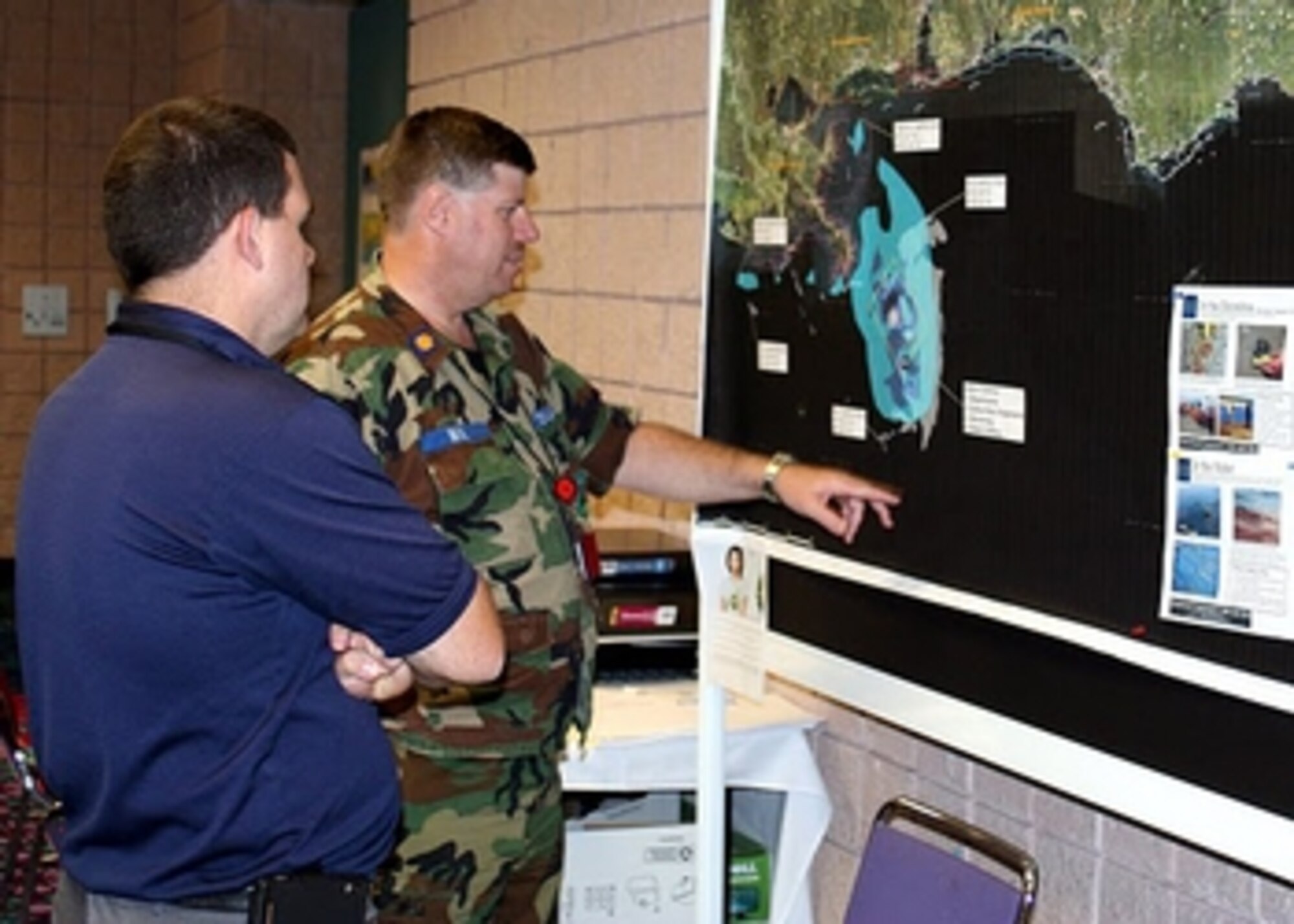 Maj. John Neil (right), the Alabama Wing’s director of operations and, and Capt. Glenn Wilson, an imaging expert from the wing’s Bessemer Composite Squadron, examine a coastal map at the Operation Deepwater Horizon command center in Mobile, Ala. Photos by Capt. Phil Norris