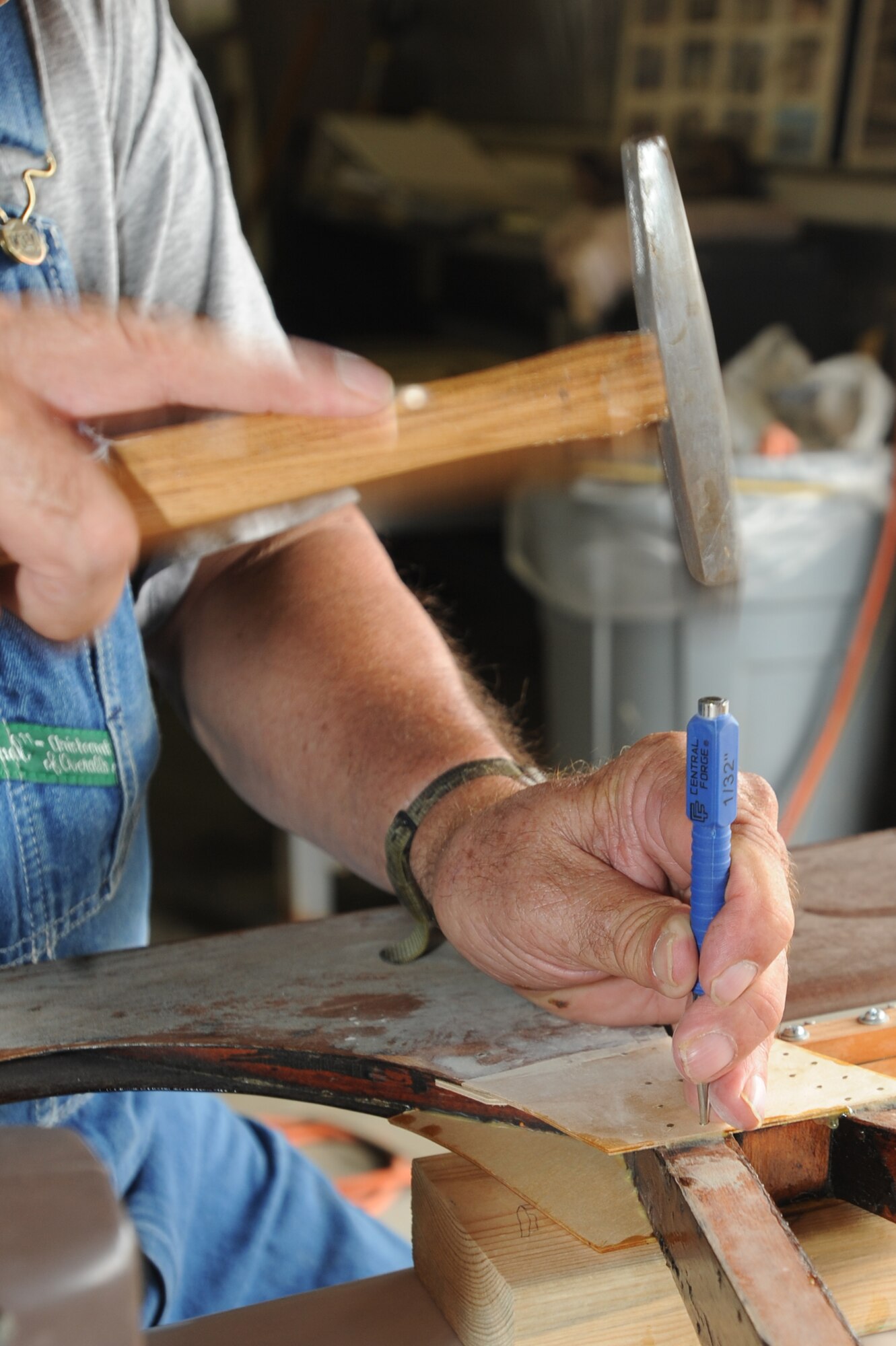 WHITEMAN AIR FORCE BASE, Mo. - Arthur Miller, Waco glider restoration project volunteer, countersinks nails on the rudder section before smoothing the surface with putty July 7.  In 1942, US Army Air Corps officials selected the site of the present-day base to be the home of Sedalia Army Air Field, a training base for WACO glider pilots.U.S. Air Force photo/ Senior Airman Carlin Leslie) (Released)
