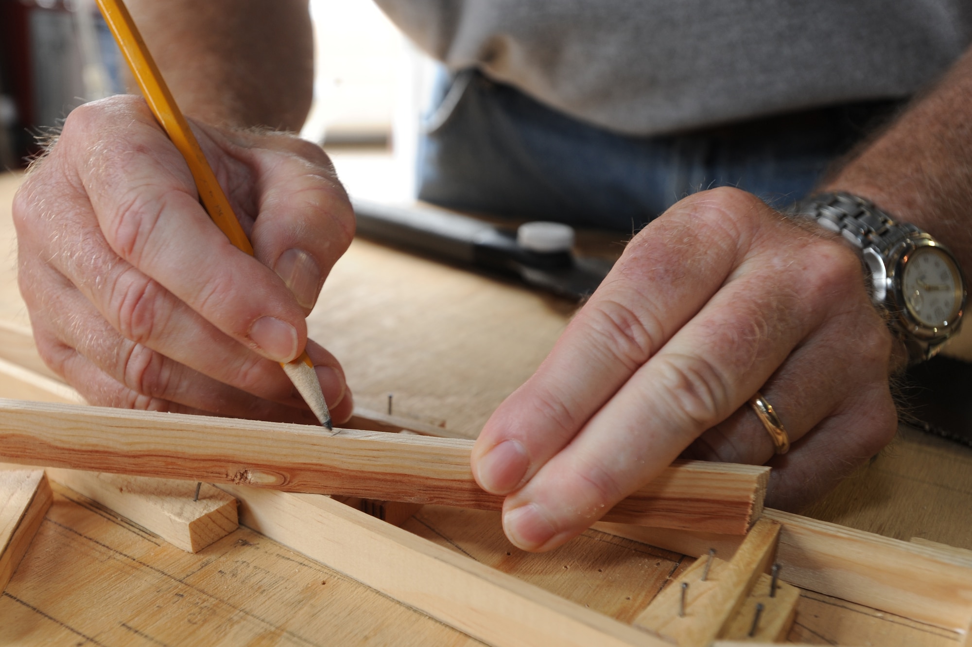 WHITEMAN AIR FORCE BASE, Mo. - Tom O'Neil, Waco glider restoration project volunteer, marks out a cutting point for a rib support, July 7. The WACO glider wings consist of more than 100 ribs, and involves many hours to build each one.(U.S. Air Force photo/ Senior Airman Carlin Leslie)(Released)
