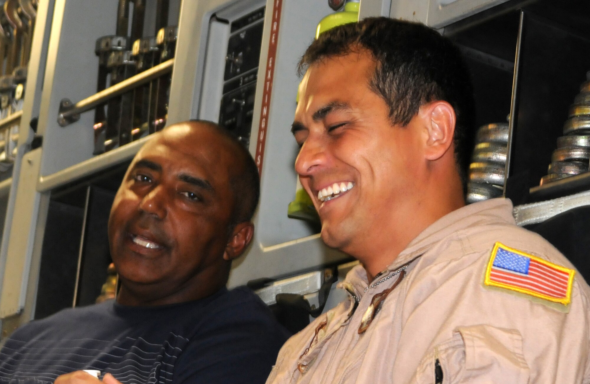 Coach Marvin Lewis, Cincinnati  Bengals head coach, shares a laugh with Tech. Sgt. Harry Pollock, 326th Airlift Squadron, Dover Air Force Base, Del., loadmaster, in the cargo area of a C-17 Globemaster III June 29. The aircrew picked up the four National Football League coaches who were participating in the 2010 NFL-USO Coaches' tour at Ramstein Air Base, Germany. The crew was slated to transport the coaches to Bagram Air Base, Afghanistan. (U.S. Air Force photo/Senior Airman Andria J. Allmond)
