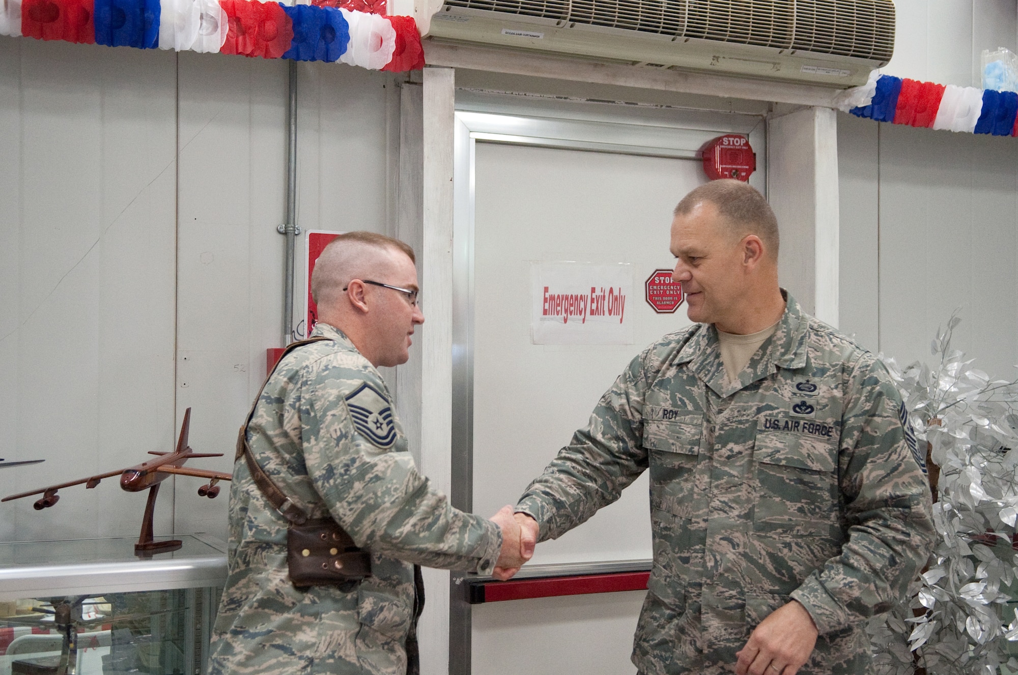 VICTORY BASE, Iraq - Master Sgt. James Bennette, 321st Air Expeditionary Wing, Iraqi Training and Advisory Mission, receives a personal coin from Chief Maser Sgt. James Roy, Chief Master Sgt. of the Air Force, June 29 for outstanding work during the drawdown conference held at Victory Base Complex, Iraq in May. Sergeant Bennette is a deployed manpower analyst from the 55th Force Support Squadron here. U.S. Air Force photo by Senior Master Sgt. Elizabeth Gilbert