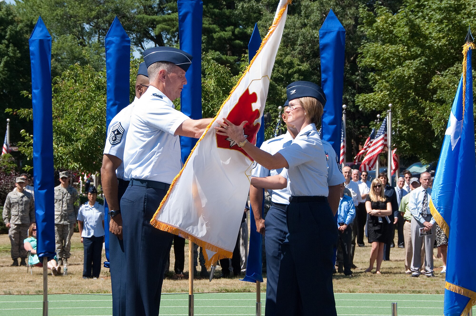 Col. Stacy Yike accepts the 66 Air Base Group flag from Lt. Gen. Ted Bowlds during the group's activation on June 30. The 66th Air Base Wing was inactivated earlier in the ceremony. (U.S. Air Force photo by Rick Berry.)
