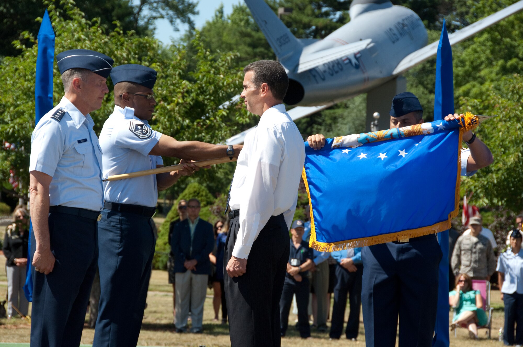 Electronic Systems Center Commander Lt. Gen. Ted Bowlds and Ronald Mason, PEO for Cyber/Net-centric Operations, stand at attention as the 653rd Electronic Systems Wing flag is furled for the final time. (U.S. Air Force photo by Rick Berry.)
