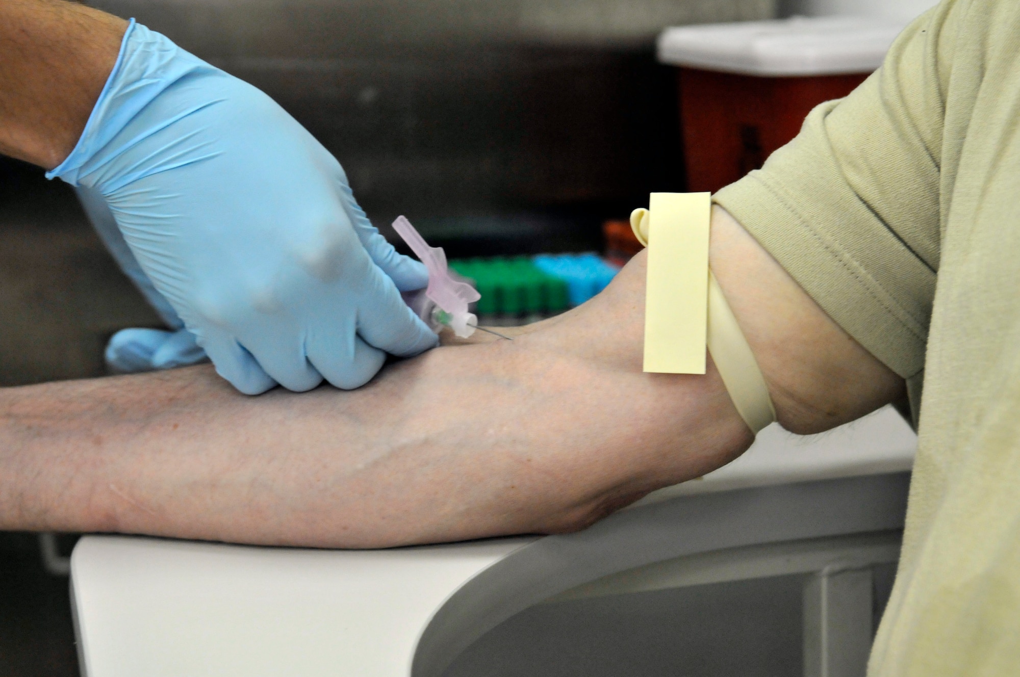 Army Spec. Christopher Whiteside, 163 Area Support Medical Company aphaeresis lab technician, inserts a needle into the arm of Army Chief Warrant Officer 2 Norman Young, 15th Military Intelligence Battalion accreditation officer in charge, to draw a test sample of blood to determine ability to donate platelets July 5, 2010, Joint Base Balad, Iraq. The aphaeresis lab tests donor’s blood before each procedure. Specialist Whiteside is deployed from the North Carolina National Guard and Warrant Officer Young is deployed from Fort Lewis, Wash. (U.S. Air Force photo/Staff Sgt. Phillip Butterfield)