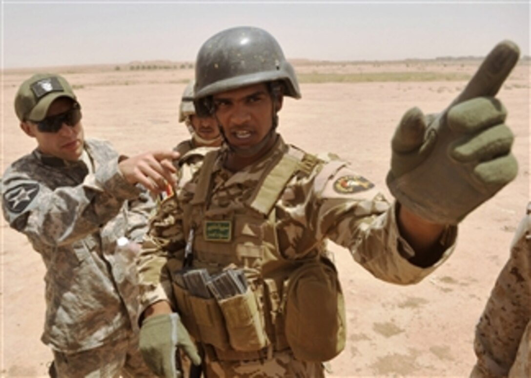 U.S. Army 1st Lt. J.D. Caddell (left), from Bravo Company, 5th Battalion, 20th Infantry Regiment, 3rd Stryker Brigade Combat Team, 2nd Infantry Division, discusses maneuvers with a team leader from the Iraqi Commando Battalion, 18th Brigade before a squad live-fire exercise at Kirkush Military Training Base, Diyala province, Iraq, on June 27, 2010.  