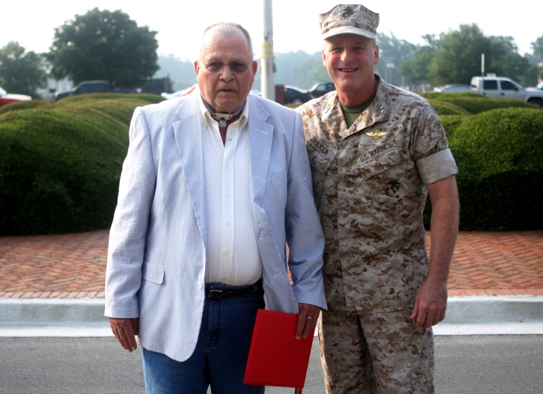 Richard M. Johnson (left) general foreman at the Ammunition Supply Point aboard Marine Corps Base Camp Lejeune, stands with Maj. Gen. Carl B. Jensen, commanding general of Marine Corps Installations East, after being presented a certificate of commendation for his combined 50 years of Department of Defense service after morning colors in front of Building 1, July 8. Johnson has given half a century to the Department of Defense, lauding him with this recognition.