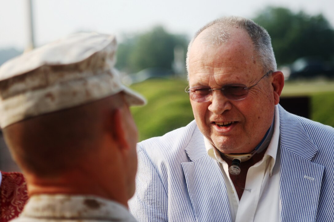 Richard M. Johnson, general foreman at the Ammunition Supply Point aboard Marine Corps Base Camp Lejeune is congratulated by Marines for the award he received in front of Building 1, July 8. The award was for Johnson's 50 years of service to the Marine Corps; 20 as a Marine and 30 in the civil service.