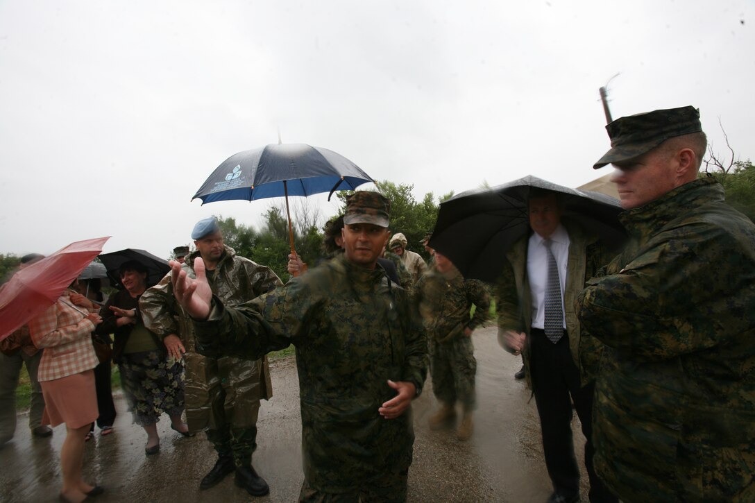 1st Lt. Marc Tucker, the platoon commander for scout platoon, 1st Tank Battalion, describes the riot-control portion of a situational training exercise conducted by U.S. Marines and Bulgarian soldiers, to James B. Warlick Jr., the U.S. ambassador to Bulgaria, at Novo Selo Training Area, Bulgaria, July 8.
