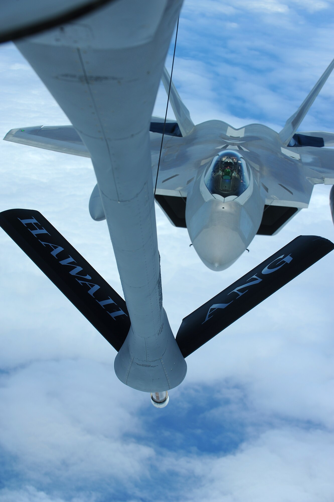 The first Hawaii-based F-22 Raptor, the U.S. Air Force’s most advanced fighter jet, soars over the Pacific Ocean July 2 en route to its new home at Joint Base Pearl Harbor Hickam, Hawaii. The first two of twenty F-22 Raptors, the U.S. Air Force's most advanced fighter jet, will be dedicated on Friday, July 9, 2010 at a Joint Base Pearl Harbor-Hickam ceremony at 9 a.m. at the Base Operations building. The ceremony will mark the beginning of the partnership between the Hawaii Air National Guard and the active duty Air Force flying the “fifth generation? fighter at Hickam. The F-22 Raptors will be flown by pilots from the 199th Fighter Squadron, 154th Wing, Hawaii Air National Guard and active duty Air Force pilots from the 19th Fighter Squadron, 15th Wing. The aircraft will also be maintained by a combination of Hawaii Air National Guardsmen and active duty Airmen. (U.S. Air Force photo by Senior Airman Gustavo Gonzalez)