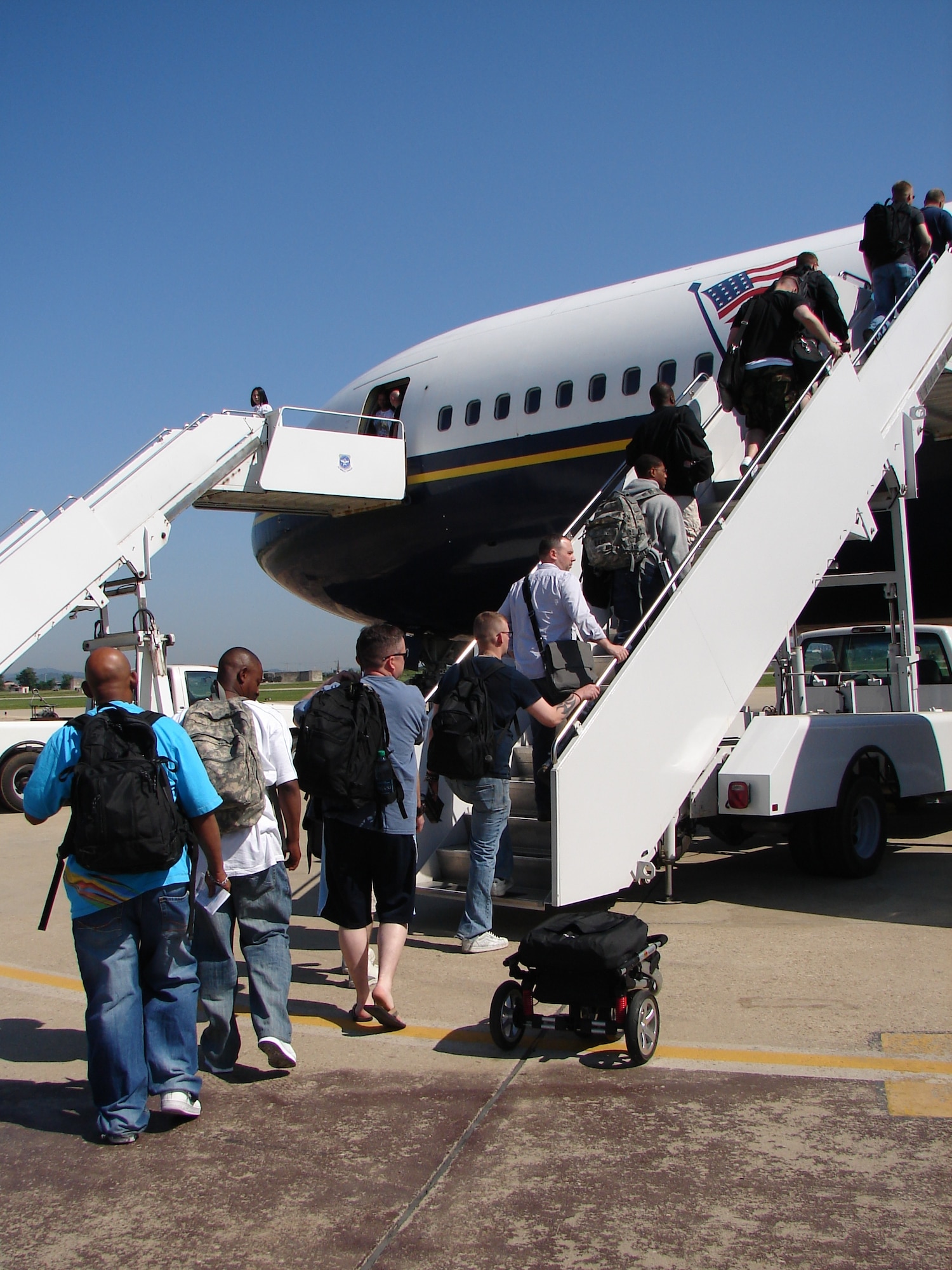 Osan passengers board a Patriot Express flight June 8, 2010. PE flights often have Space-Available seats after official duty passengers and cargo have been accommodated. (U.S. Air Force photo/Staff Sgt. Eric Burks)