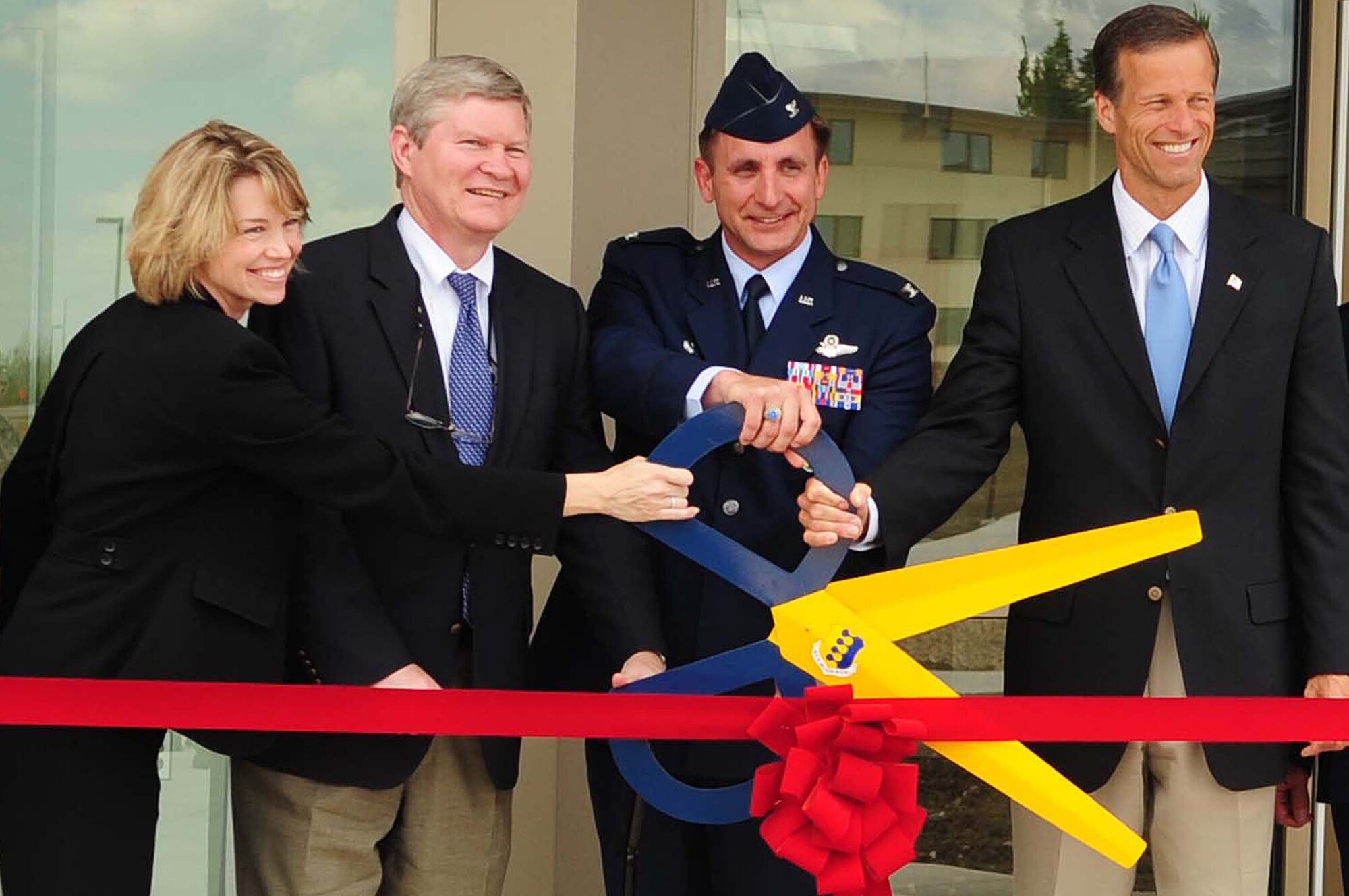 ELLSWORTH AIR FORCE BASE, S.D. - (From left to right) Representative Stephanie Herseth Sandlin, Senator Tim Johnson, Col. Jeffrey Taliaferro, 28th Bomb Wing commander, and Senator John Thune, cut the ribbon for the new 28th Civil Engineer Squadron building, July 7. The new building is the first Leadership in Energy and Environmental Design (LEED) silver-certified building on Ellsworth. (U.S. Air Force Photo/Airman 1st Class Corey Hook)