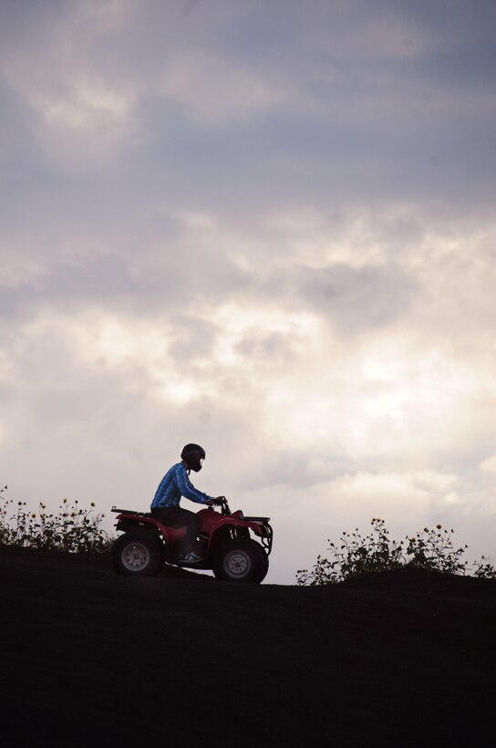 ELLSWORTH AIR FORCE BASE, S.D. -- Airman 1st Class Michael Obringer, 28th Maintenance Squadron aircrew egress systems journeyman, rides an all-terrain vehicle across a hill top at the Buffalo Gap National Grasslands, S.D., July 7.  Before riding an ATV, it's important to wear the proper protective equipment. (U.S. Air Force photo/Airman 1st Class Anthony Sanchelli)