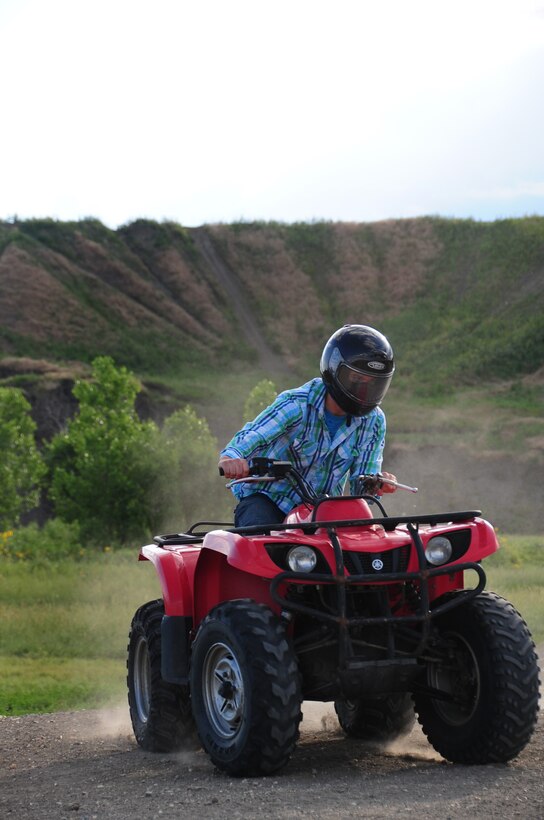 ELLSWORTH AIR FORCE BASE, S.D. -- Airman 1st Class Michael Obringer, 28th Maintenance Squadron aircrew egress systems journeyman, turns around on an all-terrain vehicle at the Buffalo Gap National Grasslands, S.D., July 7.  Airman Obringer observes safe practices by taking it slow and rides to his level of comfort, as he has never ridden an ATV before. (U.S. Air Force photo/Airman 1st Class Anthony Sanchelli)