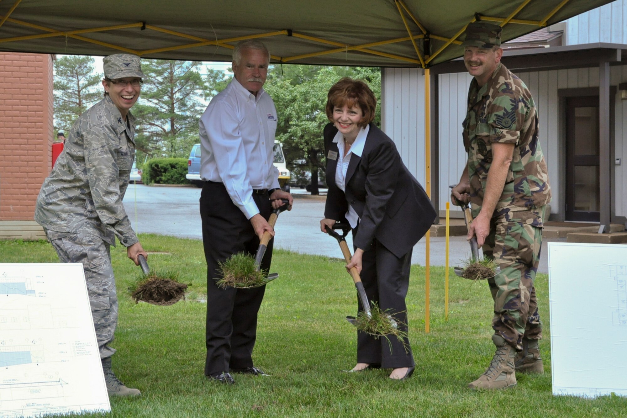YOUNGSTOWN AIR RESERVE STATION, Ohio -- U.S. Air Force Reserve Col. Teresa Hams, the 910th Mission Support Group Commander, Jerry Cardinal, the Director of Services for Air Force Reserve Command Headquarters, Nancy Rubino, the 910th Services Director, and Staff Sgt. Andy Ford, the club advisory council co-chairman, dig into the dirt at the site of the new club here, June 24, 2010. Construction is scheduled to be completed in approximately one year. U.S. Air Force photo by Senior Airman Brenda Haines 
