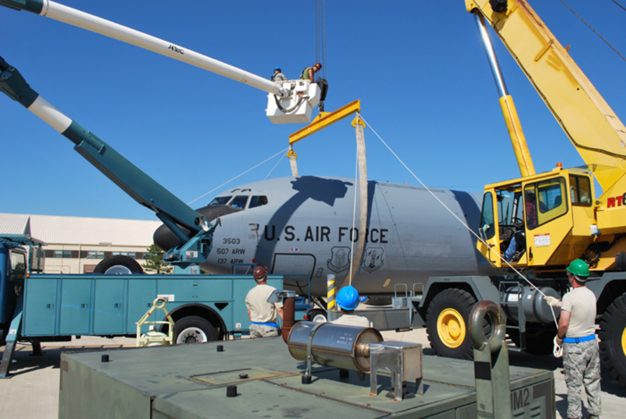 Joint maintenance teams from the Air Force Reserve and Air National Guard work together with Tinker Air Force Base crews to practice CDDAR (Crashed, Damaged, Disabled and Recovery) skills on a 507th Air Refueling Wing KC-135.  Shown here, the team carefully positions a lifting strap around the aircraft fuselage.  In the case of a damaged aircraft, the strap would then lift the aircraft allowing maintenance teams to positions jack stands prior to actual repairs.  Because of the aircraft's operational status, no actual lifting occured.