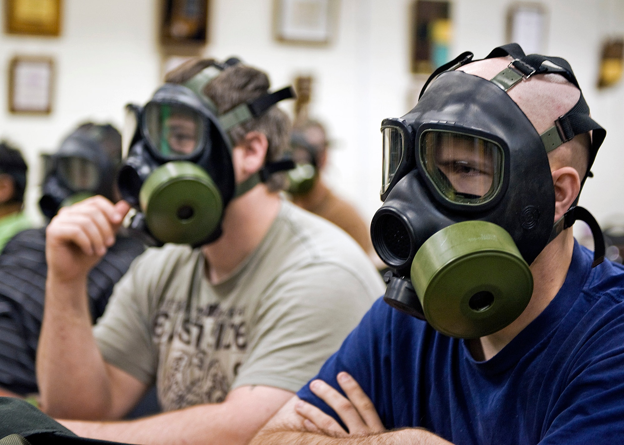 Defense Department civilians and contractors, part of the civilian expeditionary work force, learn how to wear an Army gas mask and receive a class in chemical, biological and radiological warfare June 29, 2010, at the Regional Training Institute at Camp Atterbury Joint Maneuver Training Center in Indiana. (U.S. Army photo/John Crosby)