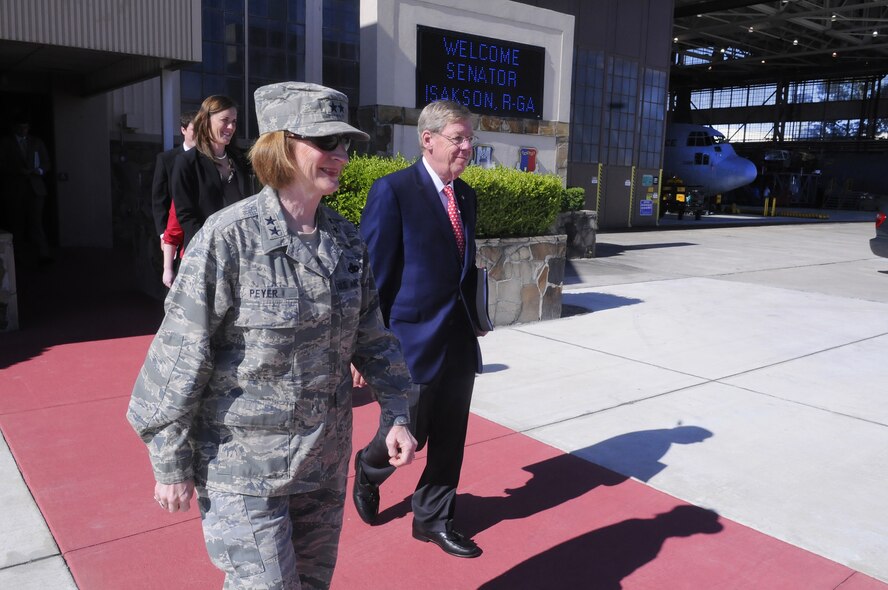 Maj. Gen Polly Peyer escorts Senator Johnny Isakson, R-Ga to an awaiting surrey during his visit to Robins July 6. Sen Isakson was given a driving tour and briefings and met with 21st Century Partnership board of directors. U. S. Air Force photo by Sue Sapp