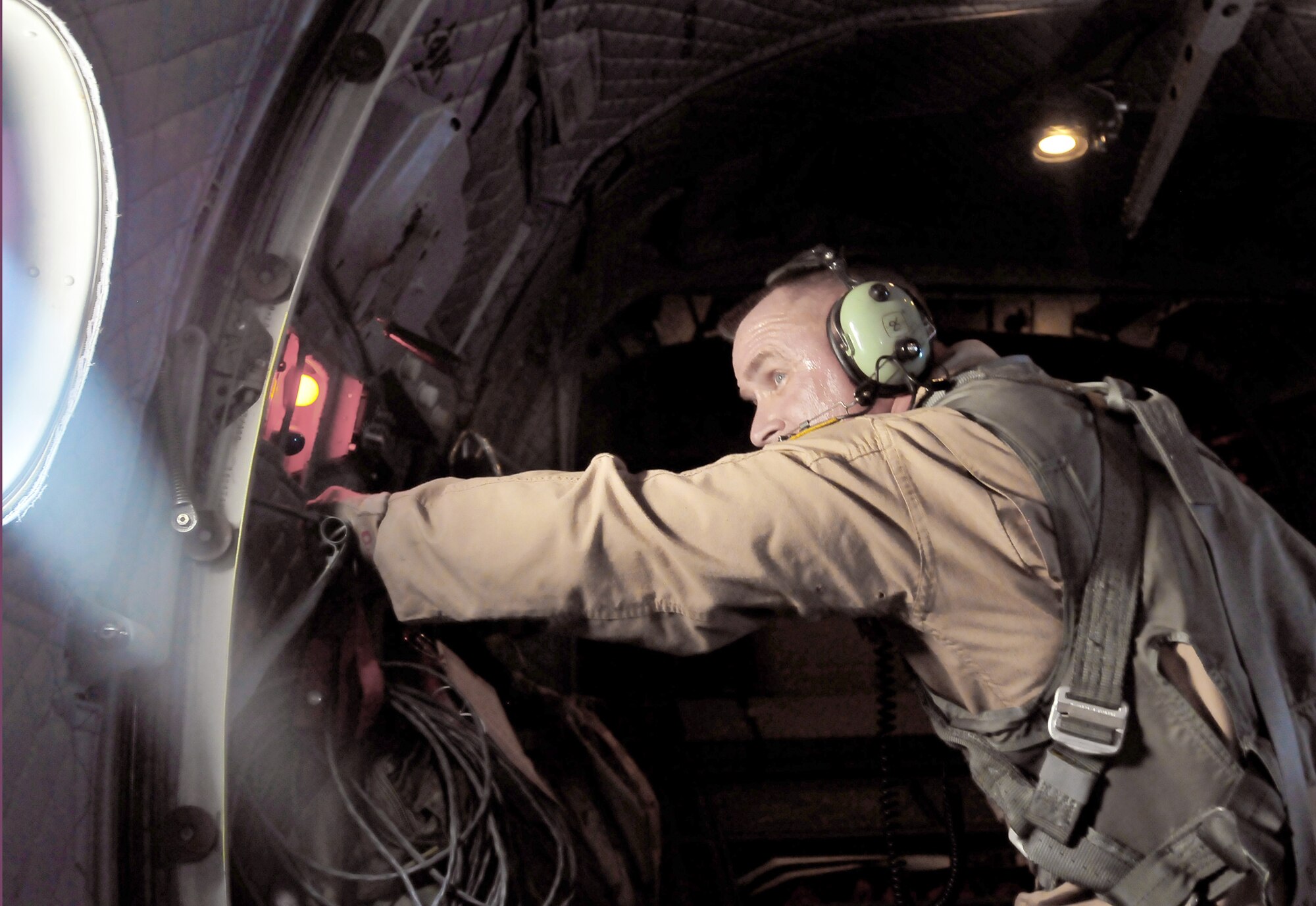 Master Sgt. Chris Ringland prepares to launch the cargo from the back of a C-27 Spartan during an airdrop July 1, 2010, over Afghanistan. This is the first air drop conducted by an aircrew for the C-27 in Afghanistan. Sergeant Ringland is with the 438th Air Expeditionary Advisory Group.  (U.S. Navy photo/Petty Officer 2nd Class David Quillen)

