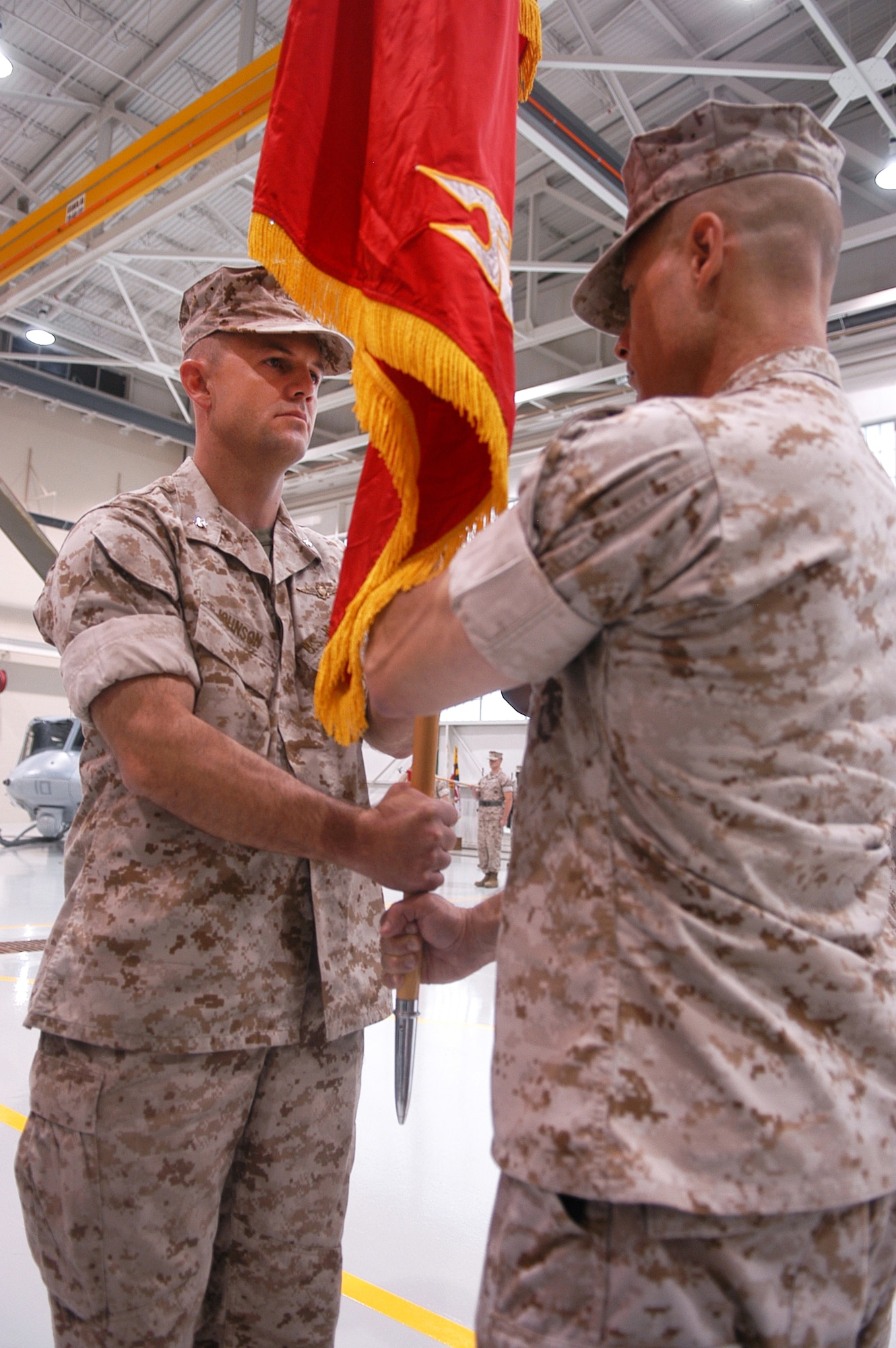 Lt. Col. Michael Johnson accepts the group colors to become the commander of Marine Aircraft Group 49, Detachment A during a change of command ceremony July 1.  U. S. Air Force photo by Sue Sapp