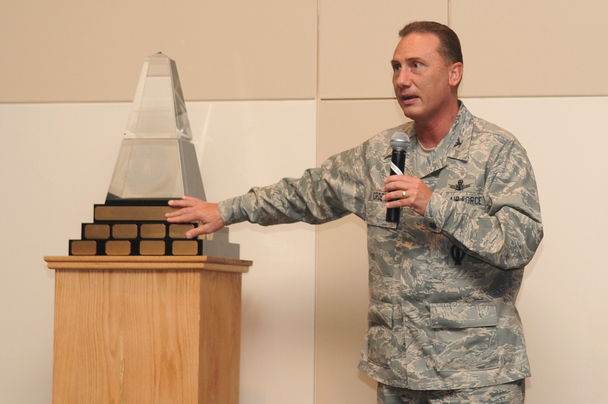 BUCKLEY AIR FORCE BASE, Colo. -- Col. Clint Crosier, 460th Space Wing commander, unveils the Aldridge Trophy for Best Space Wing to Team Buckley at his commander's call July 7. The 460th Space Wing won the trophy for superior performance during Guardian Challenge 2010. (U.S. Air Force Photo by Airman 1st Class Manisha Vasquez) 