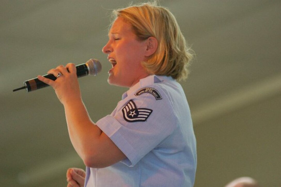 Staff Sergeant Mary Beth McFann entertains the crowd during a Dimensions in Blue performance in Fredericksburg, TX on July 4, 2010.
